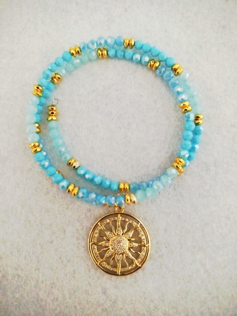 Bracciale flessibile con perle in vetro sfaccettato e charm "Raggi di sole"